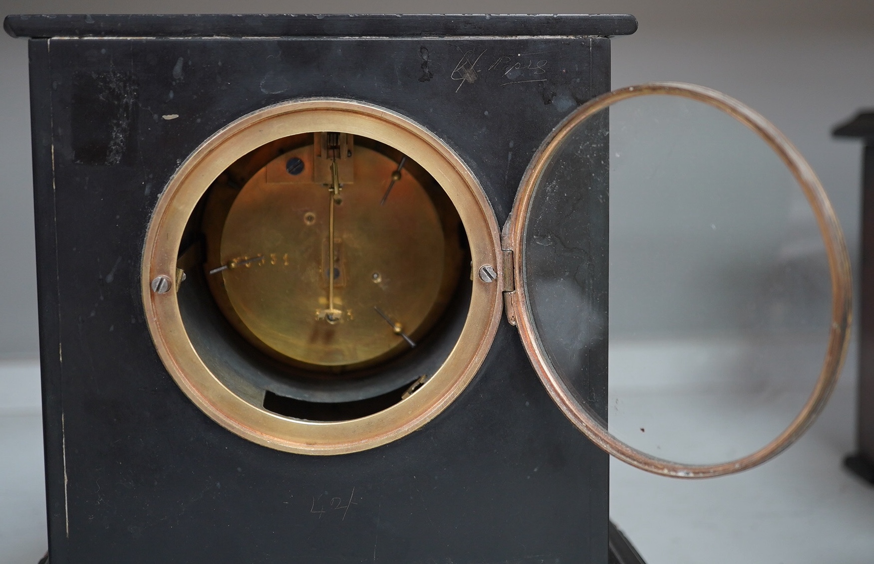 A slate mantel clock and a miniature bracket timepiece, slate clock 25cm high. Condition - miniature bracket time piece, polish on top worn,slate clock has fine scratch.